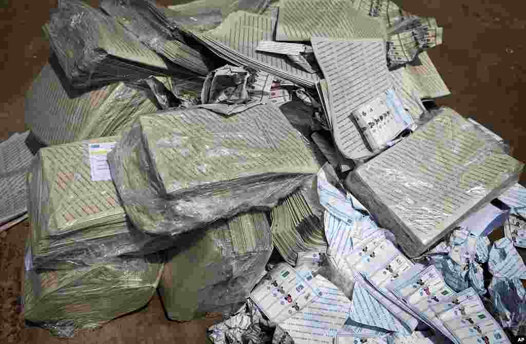 A pile of presidential and legislative ballot papers sit unattended on the ground of a compound outside a polling station in Democratic Republic of Congo's capital Kinshasa. First results emerged from the Democratic Republic of Congo's chaotic elections o