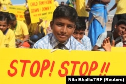A schoolboy holds a sign calling for end of child trafficking and sex abuse at an event to kick off what is expected to be the world's largest march against such crimes in Kanyakumari in India's Tamil Nadu state, Sept 11, 2017.