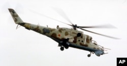 A Mi-24 helicopter gunship , the same model as the one that crashed Sunday in Syria, flies above the southern Russian city of Rostov-on-Don in this 2000 file photo.
