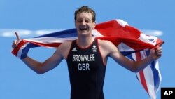 Great Britain's Alistair Brownlee reacts as he crosses the finish line to win the gold medal in the men's triathlon at the 2012 Summer Olympics, Aug. 7, 2012, in London.
