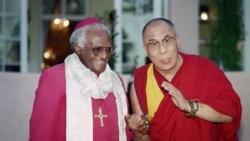 In this file photo taken on Aug. 21, 1996 Archbishop Desmond Tutu (L) meets the Dalai Lama, spiritual and political leader of the Tibetan people, in the garden of the Mount Nelson Hotel in Cape Town.