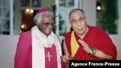In this file photo taken on Aug. 21, 1996 Archbishop Desmond Tutu (L) meets the Dalai Lama, spiritual and political leader of the Tibetan people, in the garden of the Mount Nelson Hotel in Cape Town.