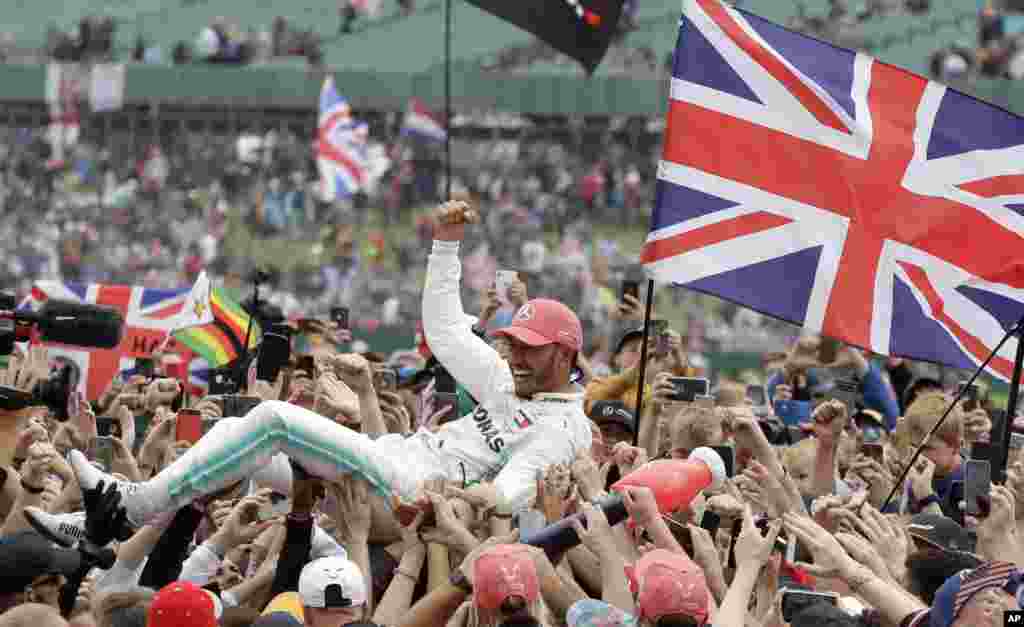 Mercedes driver Lewis Hamilton of Britain celebrates after winning the British Formula One Grand Prix at the Silverstone racetrack, Silverstone, England.