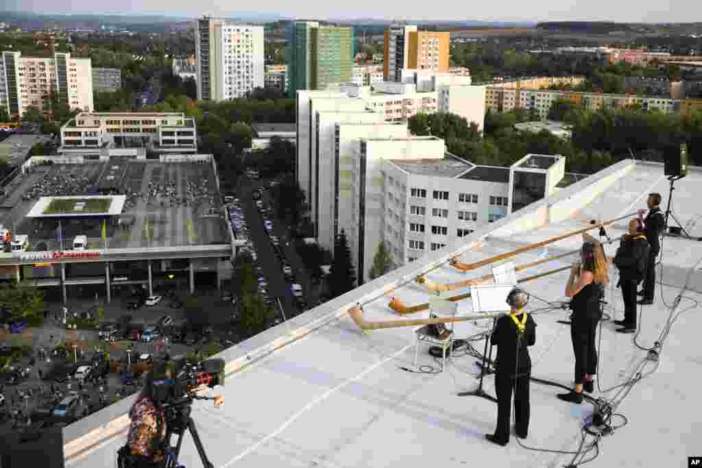Musicians with alp horns perform on the roof of an apartment block in the Prohlis neighborhood in Dresden, Germany, Sept. 12, 2020.&nbsp;