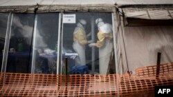 FILE - Health workers are seen inside the "red zone" of an Ebola treatment center, which was attacked in the early hours of March 9, 2019 in Butembo.