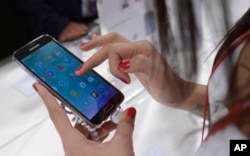 FILE - the Samsung Galaxy S5 is displayed at the Mobile World Congress in Barcelona, Spain, Tuesday, Feb. 25, 2014.