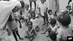 FILE - In this Oct. 25, 1979, photo, Mother Teresa (L) talks with and blesses orphans at her Sishu Bhavan (Children's Home) in Calcutta (now Kolkata), India.