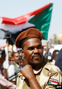 A member of the Sudanese security forces attends a rally for the supporters of President Omar al-Bashir in the Green Square in the capital Khartoum, Jan. 9, 2019.