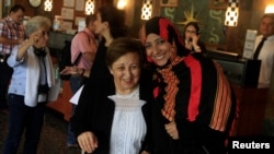FILE - Nobel Peace Prize winners Shirin Ebadi of Iran, left, and Tawakkol Karman of Yemen react while arriving to a news conference as part of the Nobel Women's Initiative, to gather a first-hand account of the ongoing violence against women land defenders, in Tegucigalpa, Honduras, Oct. 24, 2017.