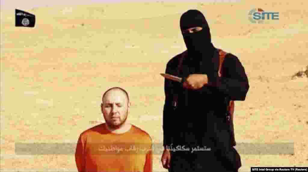 A masked, black-clad militant, identified by The Washington Post newspaper as a Briton named Mohammed Emwazi, stands next to a man purported to be Steven Sotloff in this still image from a video obtained from SITE Intel Group website, Feb. 26, 2015.