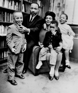 FILE - In this March 17, 1963, file photo, Dr. Martin Luther King Jr. and his wife, Coretta Scott King, sit with three of their four children in their Atlanta, Ga., home. From left are: Martin Luther King III, 5, Dexter Scott, 2, and Yolanda Denise, 7.