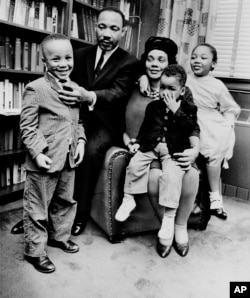 FILE - In this March 17, 1963, file photo, Dr. Martin Luther King Jr. and his wife, Coretta Scott King, sit with three of their four children in their Atlanta, Ga., home. From left are: Martin Luther King III, 5, Dexter Scott, 2, and Yolanda Denise, 7.