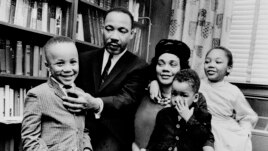 FILE - In this March 17, 1963, file photo, Dr. Martin Luther King Jr. and his wife, Coretta Scott King, sit with three of their four children in their Atlanta, Ga., home. From left are: Martin Luther King III, 5, Dexter Scott, 2, and Yolanda Denise, 7.