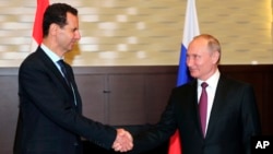 Tổng thống Nga Vladimir Putin bắt tay Tổng thống Syria Bashar al-Assad tại cuộc họp ở khu nghỉ mát Sochi trên bờ Biển Đen, Nga, ngày 17/5/2018.