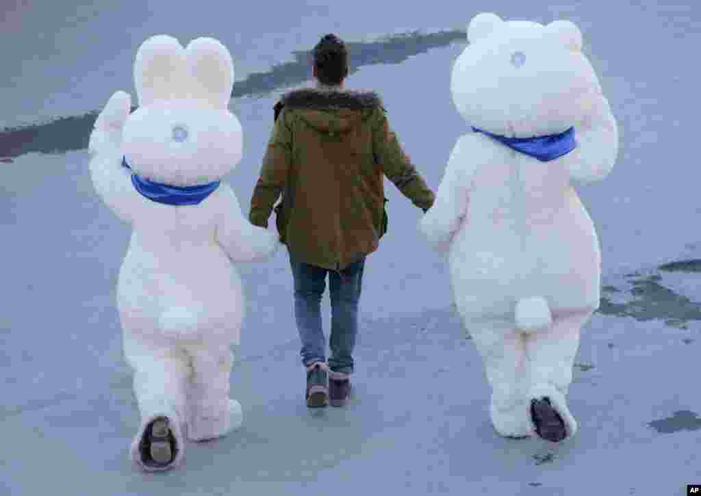 A man leads the Olympic mascots to the cross-country portion of the Nordic combined,&nbsp; Krasnaya Polyana, Russia, Feb. 12, 2014.