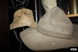 The War Store has hundreds of hats and helmets from battlefields... Including the hat in the background that belonged to a soldier killed in conflict in what's now Namibia in the 1980s. (D. Taylor/VOA)