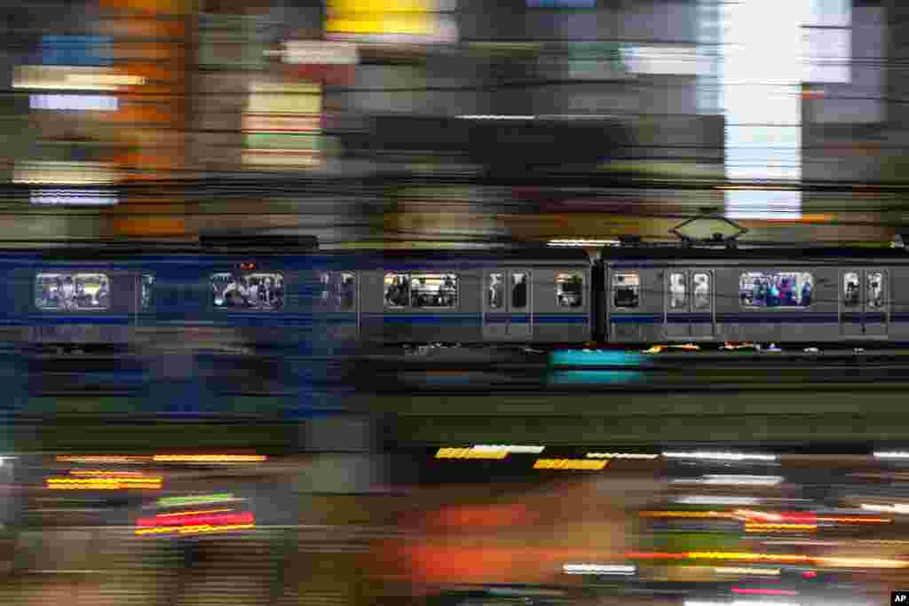 People wearing protective masks are seen on a train that is traveling through the Shinjuku district in Tokyo, Japan.