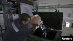 An employee burns meat at a customs house at Pulkovo Airport in St. Petersburg, Russia, August 6.