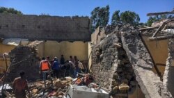 Residents sift through rubble from a destroyed building at the scene of an airstrike in Mekele, in the Tigray region of northern Ethiopia, Oct. 28, 2021.