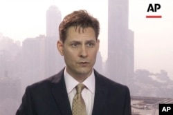 FILE - In this image made from a video taken on March 28, 2018, North East Asia senior adviser Michael Kovrig speaks during an interview in Hong Kong.
