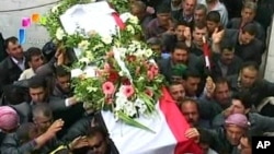 Syrian state television video footage shows mourners carrying a coffin during the funeral of two members of the security forces after they were allegedly killed by "armed groups", in Hama, north of Damascus, on April 10, 2011