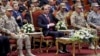 In this photo released by the Egyptian president's office, Egyptian President Abdel Fattah el-Sissi, center, attends a conference commemorating the country's martyrs, in Cairo, March 15, 2018. Up for re-election in less than two weeks, Egypt's president on Thursday took center stage at a televised ceremony declaring his readiness to personally join the battle against militants and decorating soldiers and families of fallen ones.