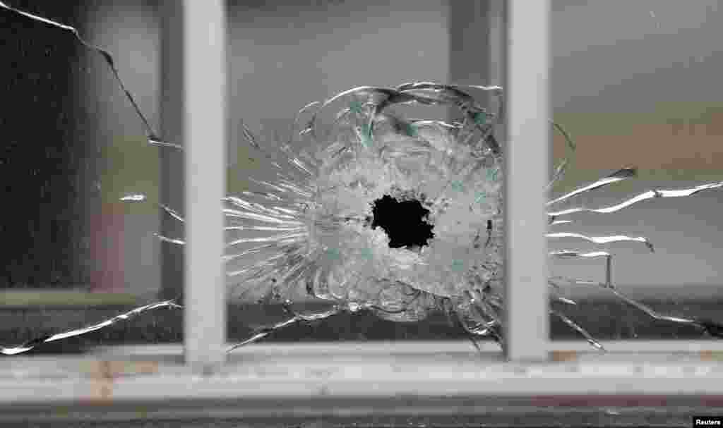 A bullet&#39;s impact is seen on a window at the scene after a shooting at the Paris offices of Charlie Hebdo, a satirical newspaper, Jan. 7, 2015.