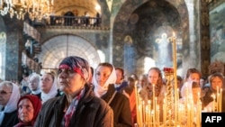 FILE - Hundreds of believers attend a church service on the Feast of the Intercession of the Virgin Mary in the Kiev-Pechersk Lavra monastery, which is the headquarter of Ukrainian Orthodox Church of Moscow Patriarchy in Kiev on Oct. 14, 2018.