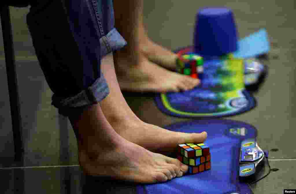 Competitors solve Rubik&#39;s cubes using their feet during the Rubik&#39;s Cube European Championship in Prague, Czech Republic.