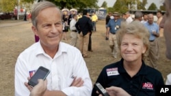 Representative Todd Akin of Missouri and his wife Lulli talk with reporters in the town of Sedalia.