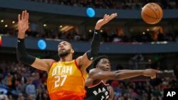 Toronto Raptors forward OG Anunoby (3) knocks the ball from Utah Jazz center Rudy Gobert (27) as he drives to the basket in the second half during an NBA basketball game, March 9, 2020, in Salt Lake City. 