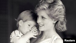 FILE - Britain's Princess Diana holds Prince Harry during a morning picture session at Marivent Palace, where the Prince and Princess of Wales are holidaying as guests of King Juan Carlos and Queen Sofia, in Mallorca, Spain Aug. 9, 1988.