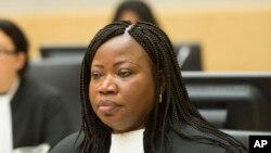FILE - Prosecutor Fatou Bensouda awaits the start of a hearing at the International Criminal Court (ICC) in The Hague, Netherlands, Monday Feb. 10, 2014. 