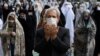 Worshippers wearing protective face masks offer Eid al-Fitr prayers outside a mosque to help prevent the spread of the coronavirus, in Tehran, Iran, Sunday, May 24, 2020. Muslims worldwide celebrate one of their biggest holidays under the long…