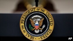 FILE - The Presidential Seal is seen on a lectern in the Roosevelt Room of the White House, in Washington, Sept. 4, 2019.