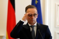 FILE - German foreign minister Heiko Maas adjusts his glasses during a news conference in Athens, Aug. 25, 2020.