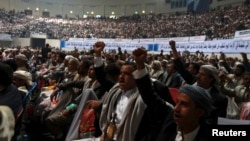 People shout slogans during a tribal gathering organized by the Shi'ite Houthi movement in Sanaa, Yemen, Oct. 31, 2014.