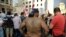 Activists hold flags and chant slogans in front of the government house during a protest against the ongoing trash crisis, in downtown Beirut, Lebanon, Tuesday, Aug. 25, 2015.