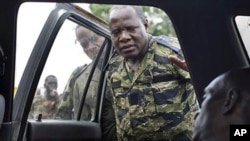 Soldiers loyal to Alassane Ouattara look at the body of a civilian who they say died as they tried to transport him for medical help at their operating base, after he was allegedly shot by militiamen loyal to Laurent Gbagbo, in Abidjan, Ivory Coast, April