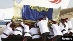 Cambodian royal officers carry the coffin of former king Norodom Sihanouk to put it on a royal truck during its arrival at Phnom Penh international airport October 17, 2012. Tens of thousands poured into Cambodia's capital to witness the procession.