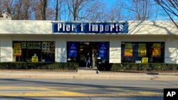 A customer steps out of a Pier 1 Imports store which was having a closeout sale, in Larchmont, N.Y., Feb. 17, 2020.