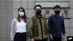 Hong Kong activists, from right, Joshua Wong, Ivan Lam and Agnes Chow arrive at a court in Hong Kong, Nov. 23, 2020.