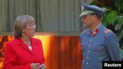FILE - Juan Emilio Cheyre, then the chief of Chile's army, talks with Michelle Bachelet, then the country's president-elect, after a meeting in her house in Santiago, Jan. 17, 2006.