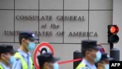 FILE - Policemen walk past the US consulate in Chengdu, southwestern China's Sichuan province, July 26, 2020. 