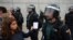 A woman shows a ballot to a Spanish Civil Guard officer outside a polling station for the banned independence referendum in Sant Julia de Ramis, Spain, Oct. 1, 2017. 