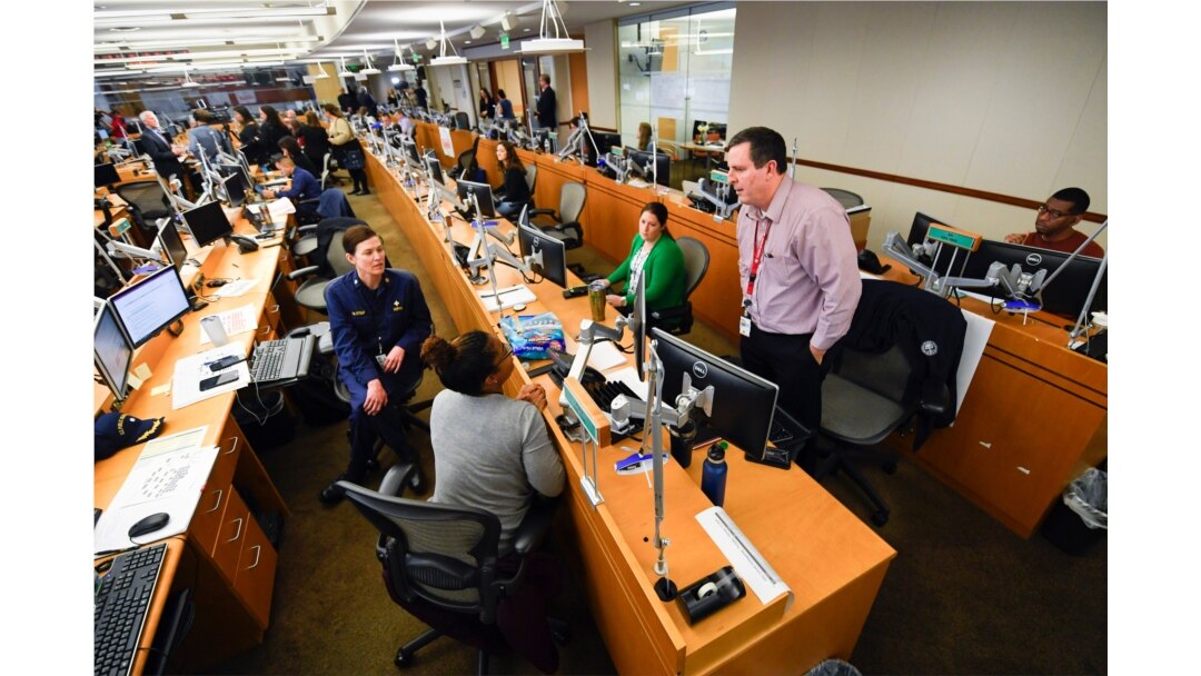 FILE - Personnel at the the Centers for Disease Control and Prevention work at the Emergency Operations Center in response to the 2019 novel coronavirus, Feb. 13, 2020, in Atlanta.