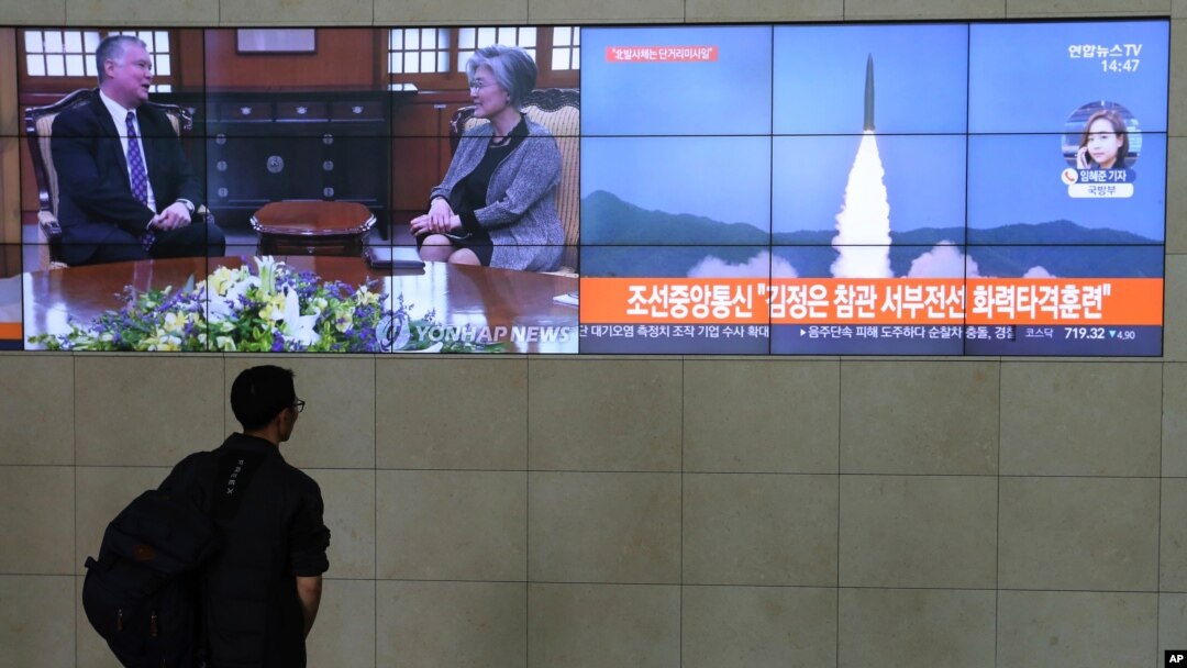 A man watches TV screens showing a photo of North Korea's weapon systems and South Korea's Foreign Minister Kang Kyung-wha meets with U.S. Special Representative for North Korea Stephen Biegun, top left, during news programs at the Yonhap News…