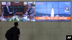A man watches TV screens showing a photo of North Korea's weapon systems and South Korea's Foreign Minister Kang Kyung-wha meets with U.S. Special Representative for North Korea Stephen Biegun, top left, during news programs at the Yonhap News…