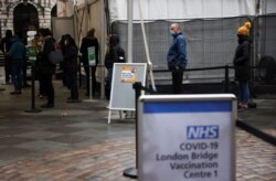 FILE - People queue at London Bridge Vaccination Centre, amid the coronavirus outbreak, in London, Britain, Jan. 5, 2021.