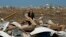 Dr. Amanda Theys sorts through the rubble of the tornado-ravaged medical clinic she works at in Moore, Oklahoma, May 21, 2013. 